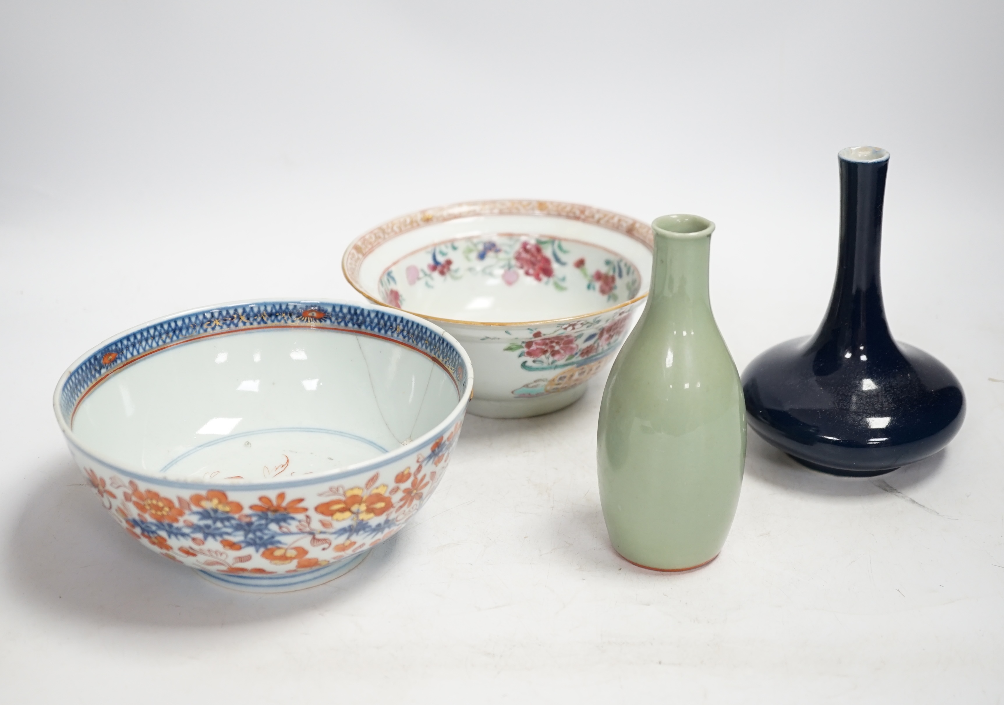 A Chinese famille rose bowl, an Imari patterned bowl, a small blue glazed vase and a similar celadon glazed vase, 18th century and later. Condition - both bowls badly cracked, overall poor
